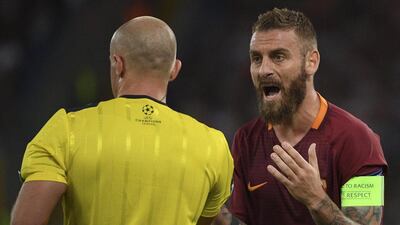 Roma's Daniele De Rossi, right, argues with referee Szymon Marciniak after getting a red card. Angelo Carconi / AP
