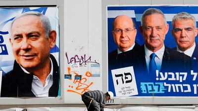 Electoral campaign posters in Tel Aviv bear the portraits of Israel's Prime Minister Benjamin Netanyahu and and retired Israeli general Benny Gantz of the Blue and White political alliance. Jack Guez / AFP