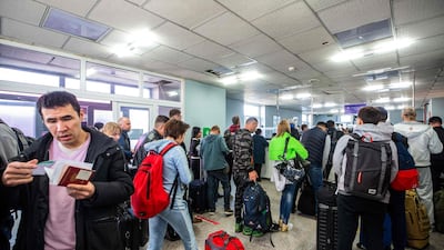 People arriving from Russia wait at the Mongolian border checkpoint of Altanbulag on Sunday. Russia's largest mobilisation since the Second World War has led to military-age men fleeing the country in droves. AFP