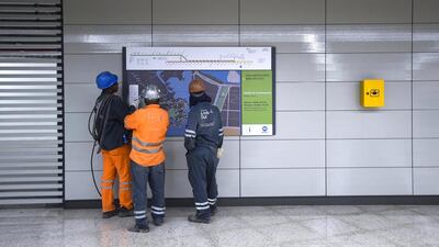 Construction workers are seen looking at a plan of the new Metro line number 4. Lukas Coch / EPA