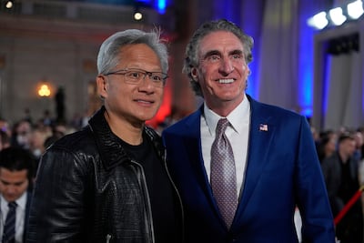 Nvidia chief executive Jensen Huang with US Interior Secretary Doug Burgum before President Donald Trump speaks during an AI summit. AP Photo