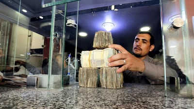 A Yemeni man holds Yemeni currency banknotes amid a continuous collapse of the rial. EPA