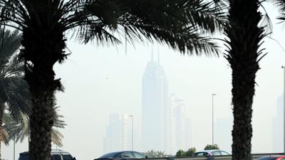 Business Central Towers covered in mist on a hazy morning in Dubai. Chris Whiteoak / The National