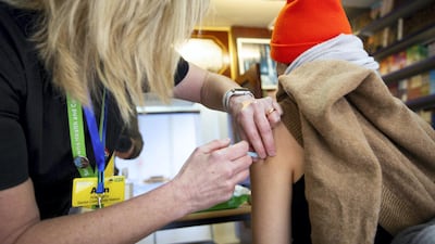 A member of the public receives a vaccine at London Central Mosque. Mark Chilvers for The National