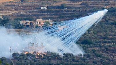 An Israeli shell that appears to contain white phosphorus explodes over a house in Al Bustan, a Lebanese village along the border with Israel, on October 15. AP