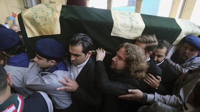 Omar (centre), son of former Lebanese minister Mohammed Chatah, carries his father's coffin along with relatives during his mass funeral at Al Amin mosque in Martyrs' Square, downtown Beirut. Hasan Shaaban / Reuters