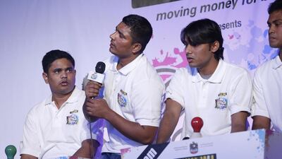Wasi Ahmed rises from his chair to sing as he answers correctly during the second round of the semi-finals of the Western Union Camp Ka Champ Grande Final held at the Jiwin Staff Accomodation in Muhaisanah 2, Sonapur.