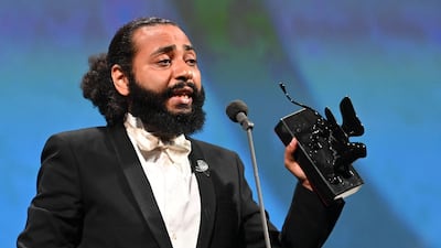 Ismael El Iraki recieves the Orizzonti Award for Best Actress on behalf of Moroccan singer and actress Khansa Batma, for 'Zanka Contact' during the 77th Venice Film Festival. AFP