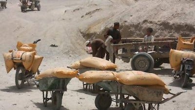 Sacks of fertiliser in wheelbarrows at Pakistani Chaman border post to be smuggled into the neighbouring Afghanistan. It is thought that enough fertiliser was smuggled into Afghanistan last year to make 140,000 bombs. Shah Khalid / AP Photo