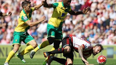 Norwich City's Alexander Tettey, centre, challenges Sunderland's Steven Fletcher during their Premier League match on Saturday at the Stadium of Light. Lindsey Parnaby / AFP
