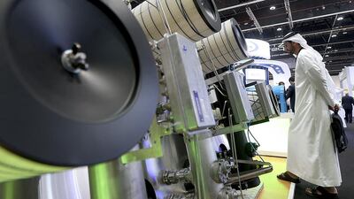 A visitor browses the Pentair stand at the POWER-GEN Middle East Conference and Exhibition in Abu Dhabi. Satish Kumar / The National