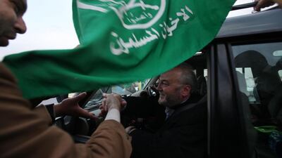 Jordanians great British MP George Galloway as they wave to the aid convoy with flags and throwing flowers on their way near the border between Jordan and Syria in 2009. (Salah Malkawi for The National)