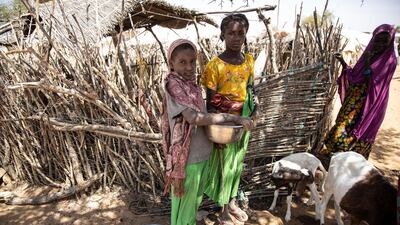 Girls stand at the Goudebo camp, a camp for Malian refugees in Burkina Faso. AFP