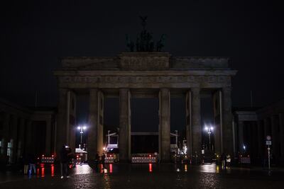 Public landmarks such as the Brandenburg Gate in Berlin were dimmed to save energy. EPA
