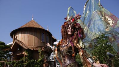 Performers pose in front of the Blue Forest Tree Houses.