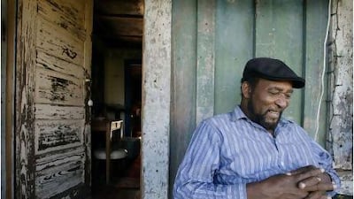 The blues musician James "Super Chikan" Johnson sits on the front porch of a shack on the Hopson plantation near Clarksdale, Mississippi. Getty Images
