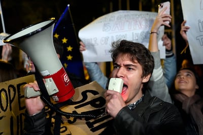 Right-wing demonstrators hold placards and shout slogans near the European Parliament headquarters in Madrid. AFP
