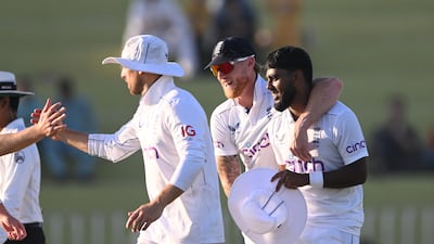 England bowler Rehan Ahmed, right, celebrates with Ben Stokes after taking the wicket of Zahid Mehmood. Getty Images