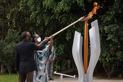 Rwanda’s President Paul Kagame (left) and his wife Jeannette Kagame light a remembrance flame at Kigali Genocide Memorial. AFP