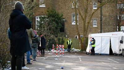 People queue to enter one of the swabbing stations of a mobile testing centre in south London. Getty
