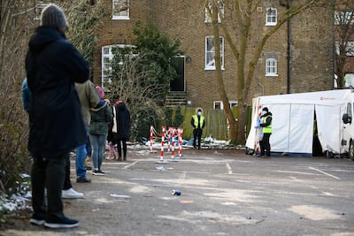 People queue to enter one of the swabbing stations of a mobile testing centre in south London. Getty