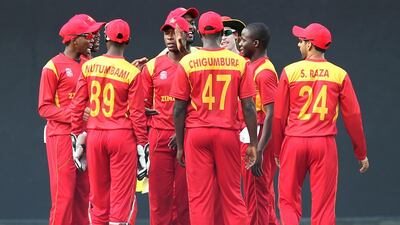 Zimbabwe’s Donald Tiripano (2R) celebrates with teammates after taking the wicket of unseen Hong Kong batsman Ryan Campbell during the opening match of the ICC World T20 cricket tournament between Hong Kong and Zimbabwe at The Vidarbha Cricket Association Stadium in Nagpur on March 8, 2016. AFP