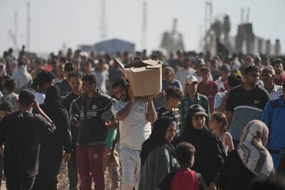 Palestinians crowd round a food bank set up by a new US and Israeli-backed foundation on its first day of operations on Tuesday. AP