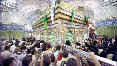 Shiite pilgrims visit the grave of Imam Abbas in Karbala.