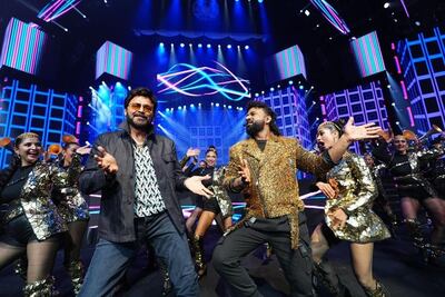 Telugu superstar Venkatesh, left, and singer DSP perform on stage at IIFA Utsavam 2024 at Etihad Arena in Abu Dhabi. Photo: IIFA