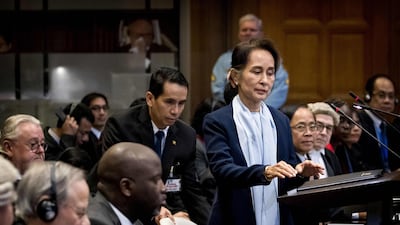 Myanmar's State Counsellor Aung San Suu Kyi (R) stands before the UN's International Court of Justice on December 11, 2019 in the Peace Palace of The Hague, on the second day of her hearing on the Rohingya genocide case. Aung San Suu Kyi appears at the UN's top court today, a day after the former democracy icon was urged to "stop the genocide" against Rohingya Muslims. Once hailed internationally for her defiance of Myanmar's junta, the Nobel peace laureate will this time be on the side of the southeast Asian nation's military when she takes the stand at the International Court of Justice. - Netherlands OUT / AFP / ANP / Koen Van WEEL