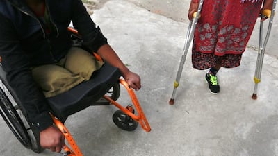 Ramesh Khattri and Dan Maya Maharjan, 47, wait at Orthopedic rehabilitation center in Kathmandu, Nepal. Narendra Shrestha / EPA