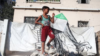 A boy holds a kite in a displacement camp in Gaza city. AFP