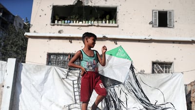 A boy holds a kite in a displacement camp in Gaza city. AFP