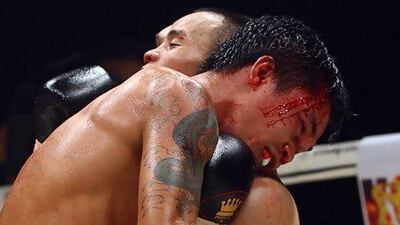 China's Xiong Zhao Zhong emerged the winner on a split decision in the Strawweight WBC Championship fight over Denver Cuello of Philippines, with tattoo, at the World Trade Centre. Satish Kumar / The National