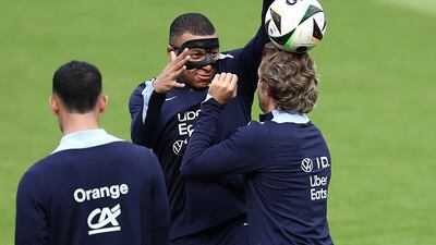 Kylian Mbappe and Antoine Griezmann share a joke. AFP