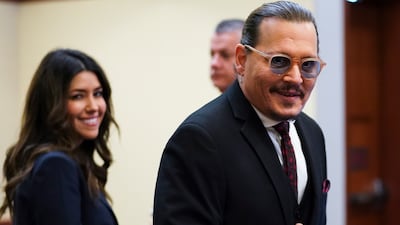 Depp arrives in the courtroom with Ms Vasquez. AP