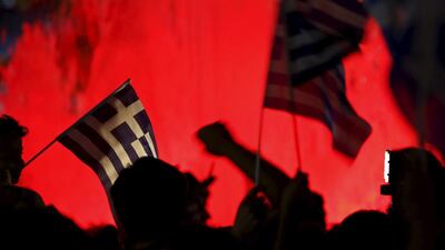 No supporters wave Greek national flags on the main Constitution square in Athens. Yannis Behrakis / Reuters