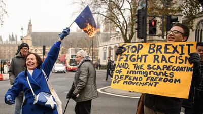 A woman burns an EU flag outside the Supreme Court on the second day of a hearing into whether Parliament's consent is required before the Brexit process can begin, on December 6, in London. Leon Neal / Getty Images