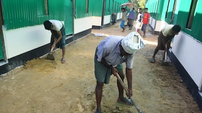 Bangladeshi labourers work in the construction site of the "Transit Camp" set up for the repatriation of Rohingya refugees at the Kutupalong refugee camp in Ukhia. AFP