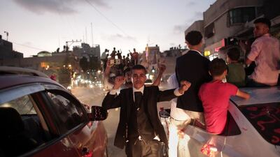 The groom, Saed Abu Aser, dances in the street on his way to the wedding hall.