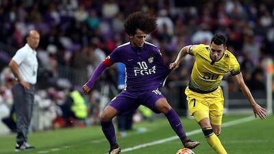 Omar AbdulRahman, left, of Al Ain and Fabio De Lima, right, of Al Wasl in action during their Arabian Gulf League match at the Hazza Bin Zayed Stadium in Al Ain. Satish Kumar / The National