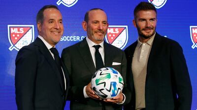 Inter Miami co-owners Jorge Mas, left, and David Beckham, right, pose for photos with Major League Soccer Commissioner Don Garber. AP