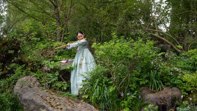 A flautist performs in Korean-inspired garden A Letter from a Million Years Past. Getty