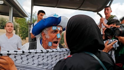 A Palestinian woman confronts an Israeli settler celebrating Jerusalem Day in the Old City on Sunday. Ahmad Gharabli / AFP