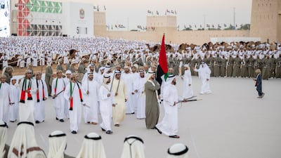 Lt Gen Sheikh Saif bin Zayed, Deputy Prime Minister and Minister of Interior, and Sheikh Khalifa bin Tahnoun, Executive Director of the Martyrs' Families' Affairs Office, participate in a traditional ayyala. Rashed Al Mansoori / Presidential Court