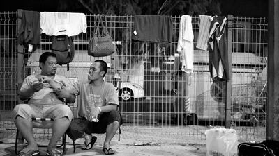 Felix Culpit picks a cigarette off his friend.
