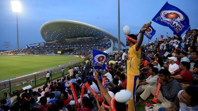 Mumbai Indians fans cheer their team against the Kolkata Knight Riders during the opening Indian Premier League match at Zayed Cricket Stadium in Abu Dhabi on April 14, 2014. Ravindranath K / The National