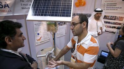 A visitor asks questions to an exhibitor at the Global Forum for Innovation in Agriculture. Silvia Razgova / The National