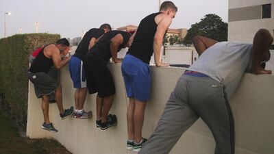 The class attempts climbing a wall in Umm Suqeim Park. Lee Hoagland / The National