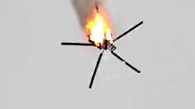 A Syrian government helicopter bursts in flames after it was hit by a missile in Idlib province on February 11, 2020. AFP